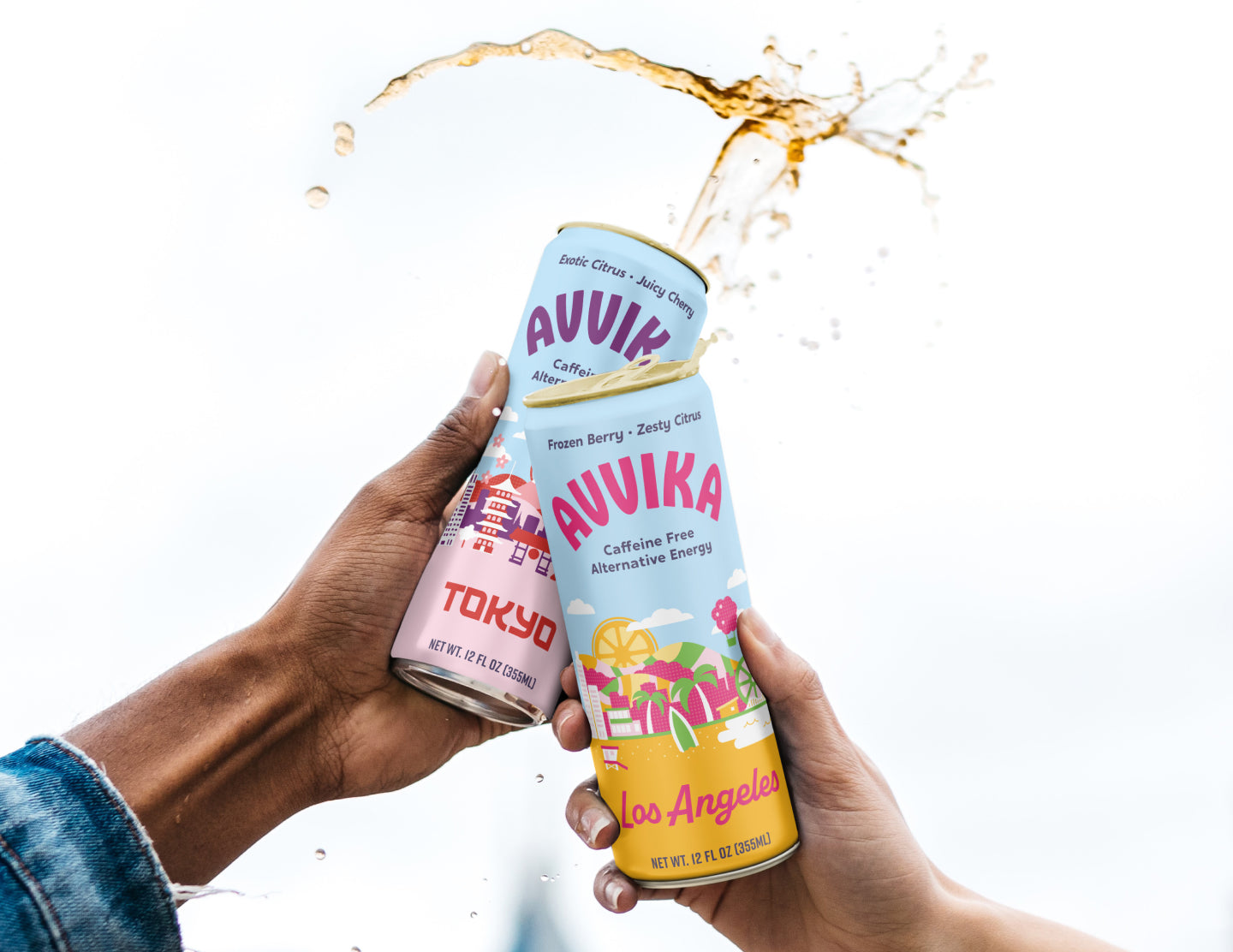 Two people holding up cans of Avvika Tokyo and Los Angeles with liquid splashing out of the top. 